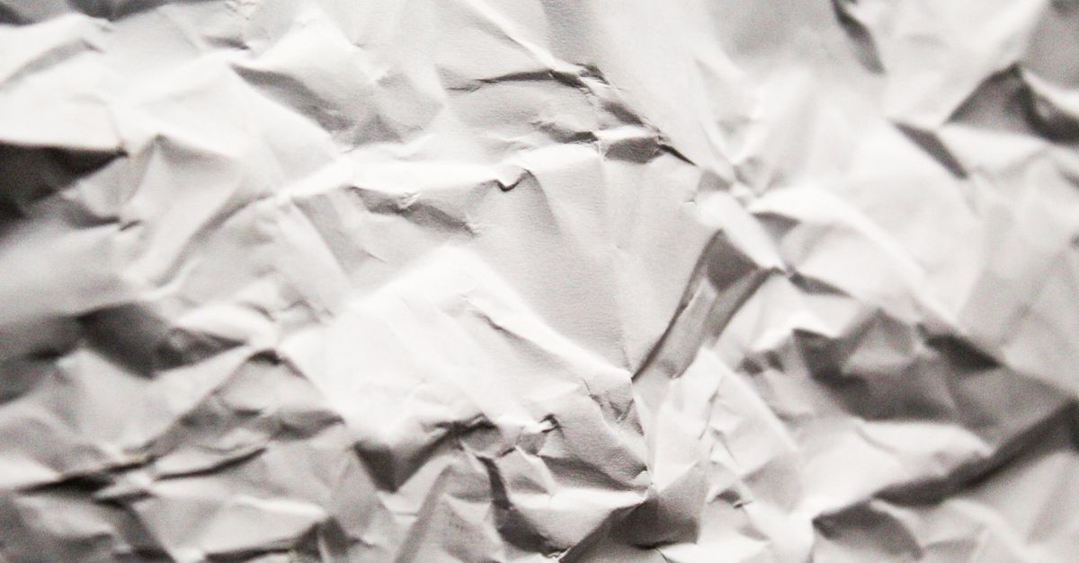 Close-up of crumpled paper showing creased cellulose fibers