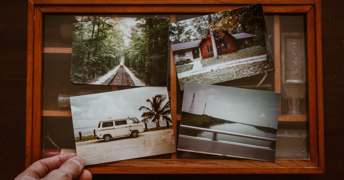 A box of old printed photographs, a metaphor for stored memories