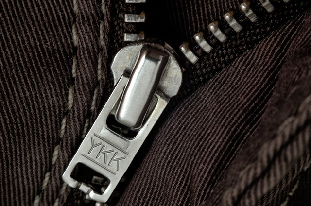 Macro close-up of interlocking metal zipper teeth