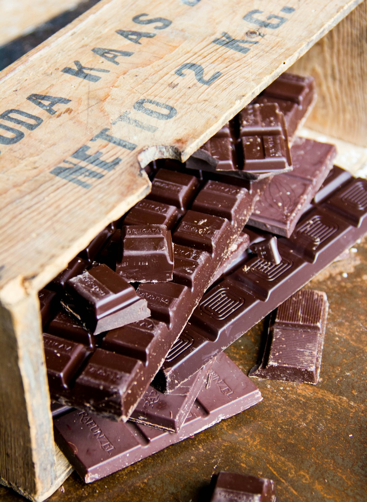 Pieces of a snapped chocolate bar in a wooden box